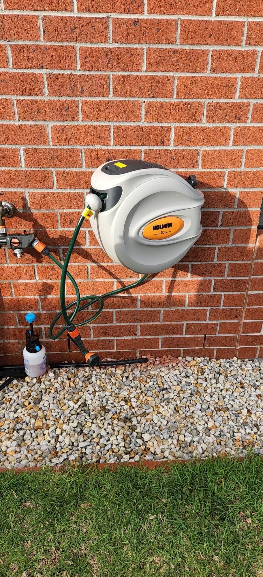 Retracting hose reel installed on to side of a house in Caulfield, melbourne.